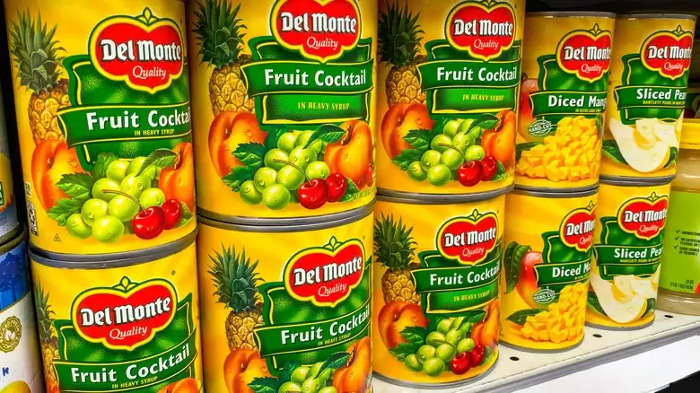 Del Monte canned fruit cocktail, mangoes and pears on a supermarket shelf